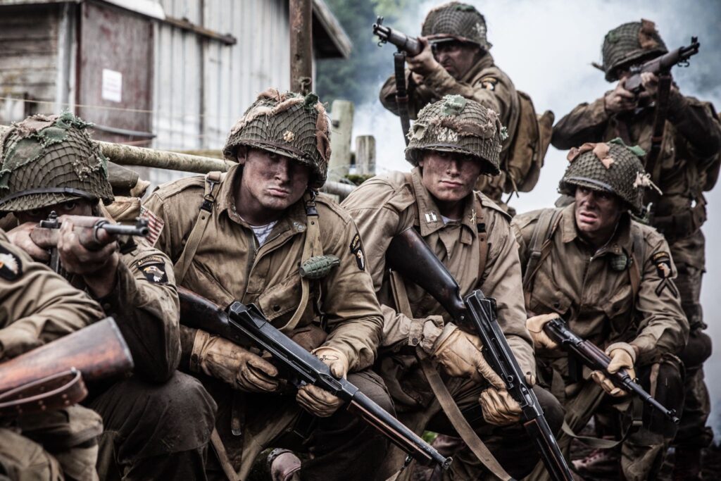 Major Stopka, Captain Rosemond, Lieutenant Provost, and Members of 502nd PIR mobilize near Carentan, France. (Dramatic Recreation) L-R: Joey McKerricher, Kylan MacKenzie, Gavin Marck, Austin Trapp