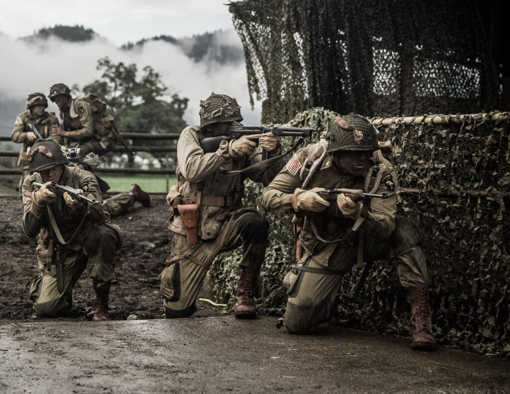 Members of 502nd PIR advance under heavy fire near Carentan, France. (Dramatic Recreation) L-R: Zachery Fiorido, Kylan Mackenzie, Austin Trapp, Joey Mckerricher