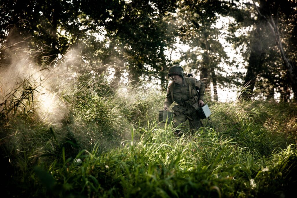 Member of 502nd PIR runs ammunition to parratroopers defending the Command Post. (Dramatic Recreation) Elliot Wesley