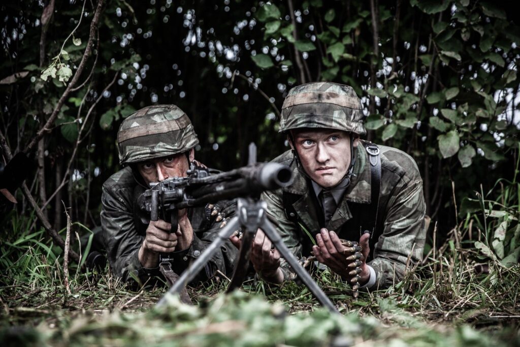 A German Machine Gun Nest fires on the American paratroopers. (Dramatic Recreation L-R: TJ Matthews, Julian Hicks