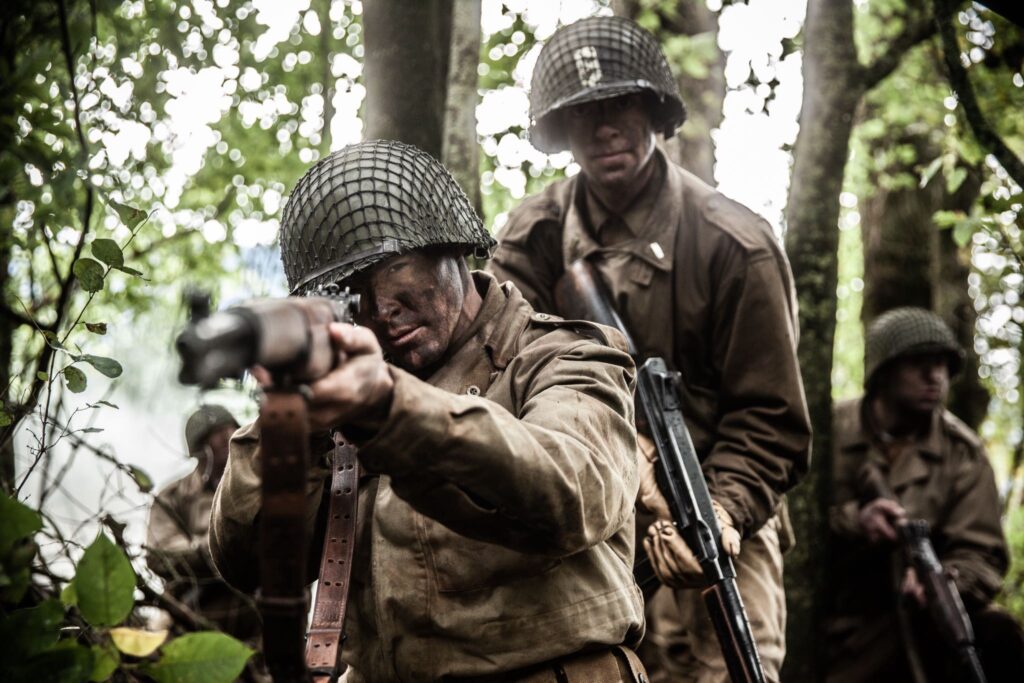 Lieutenant Higgins and the 141st Regiment establish a defensive perimeter after being cut off in the Vosges Mountains, France. (Dramatic recreation) L-R: William Grossman, Cole Breckell