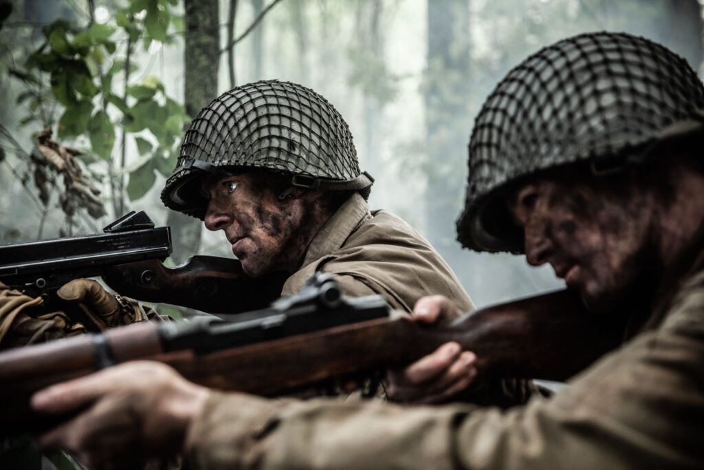 Lieutenant Higgins and 141st Soldier defend their perimeter in the Vosges Mountains after being cut off from their regiment. (Dramatic Recreation) L-R: Cole Breckell, William Grossman