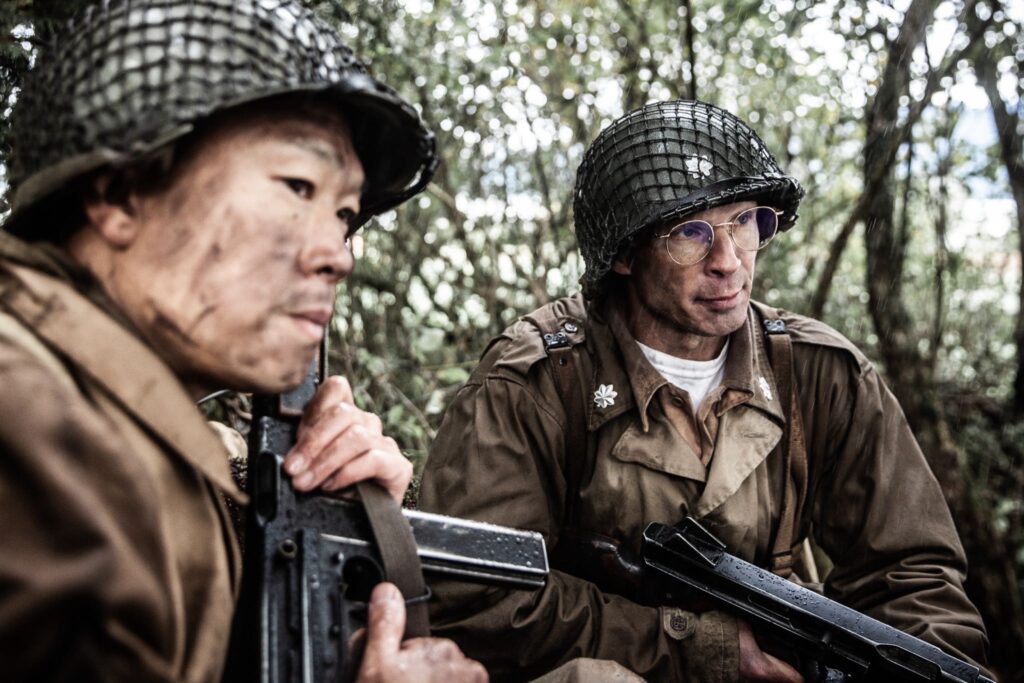 Lieutenant Colonel Pursall confers with Sergeant Shiro Kashino. (Dramatic recreation) L-R: Alex Law, Cameron Park