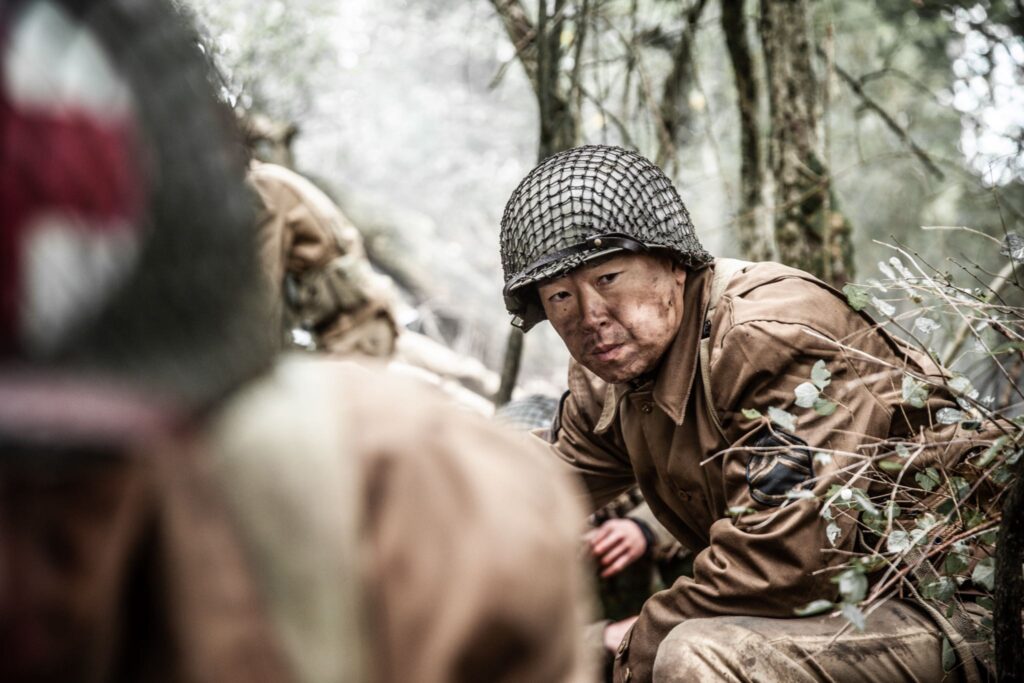 Sergeant Kashino and soldiers of 422nd Regimental Combat Team prepare to advance against enemy fire in the Vosges Mountains. (Dramatic Recreation) Alex Law