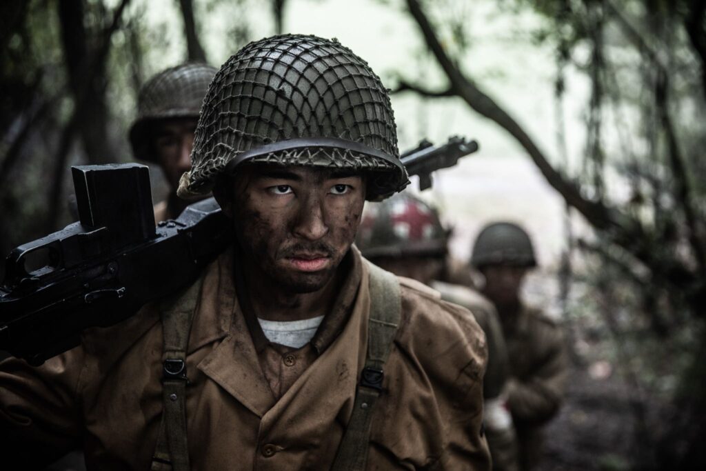 Private Barney Hajiro carries his B.A.R. in the advance to rescue the Lost Battalion. ( Dramatic Recreation) Kristopher Hori