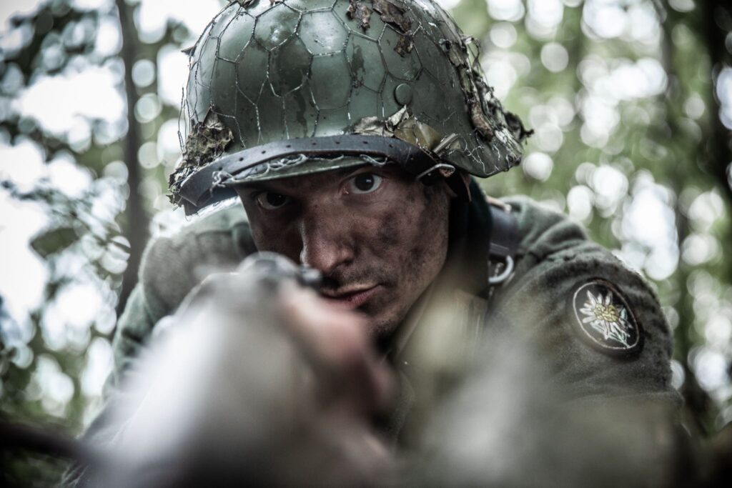 A German Mountain Battalion soldier fires machine gun in defence of their position in the Vosges Mountains. (Dramatic Recreation) Alessandro Pekin