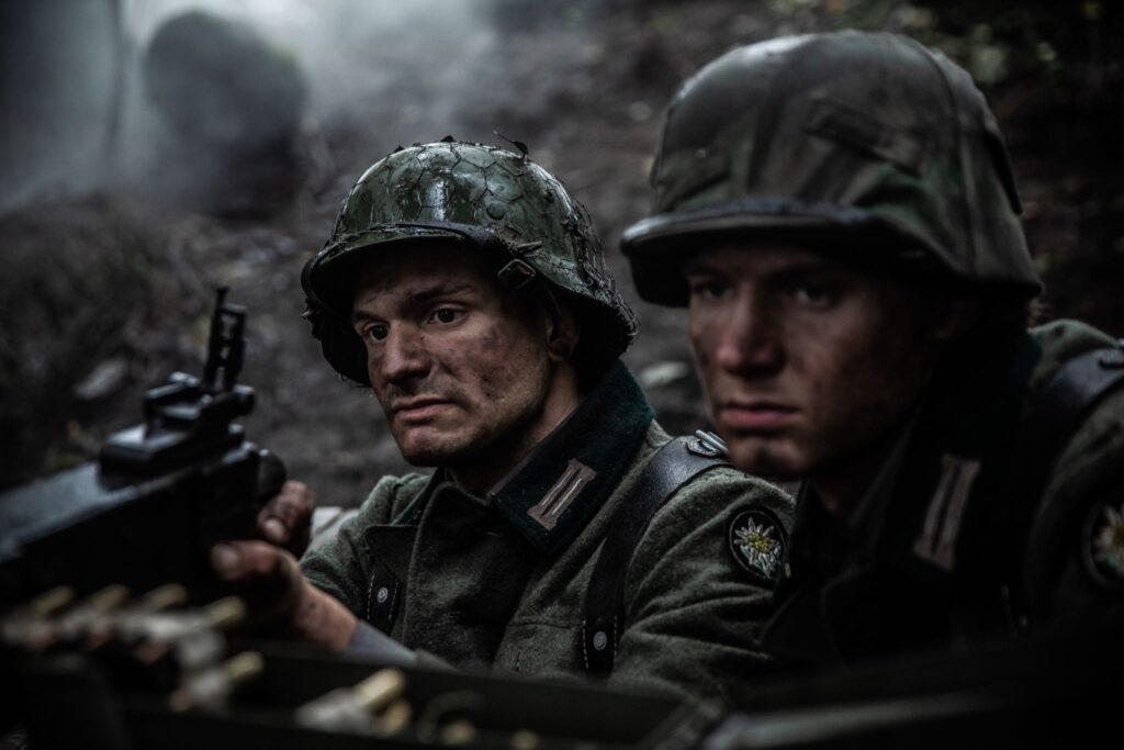 German Soldiers operate a machine gun from an uphill vantage point on Vosges Mountain. (Dramatic Recreation) L-R: Alessandro Pekin, Mitch Nel