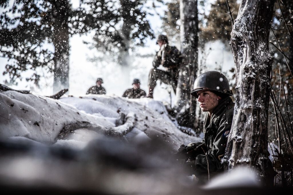 Private First Class Melvin Biddle leads the advance of 517th Parachute Inantry towards Hotton, Belgium. (Dramatic Recreation)