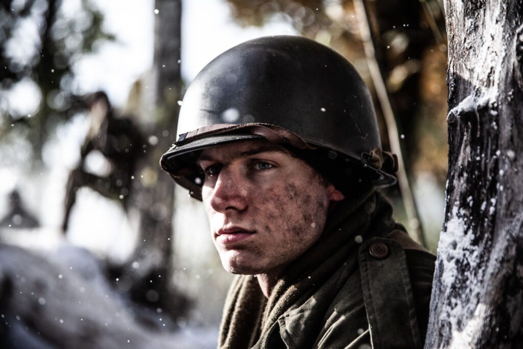 Private First Class Melvin Biddle leads the advance of 517th Parachute Inantry towards Hotton, Belgium. (Dramatic Recreation)