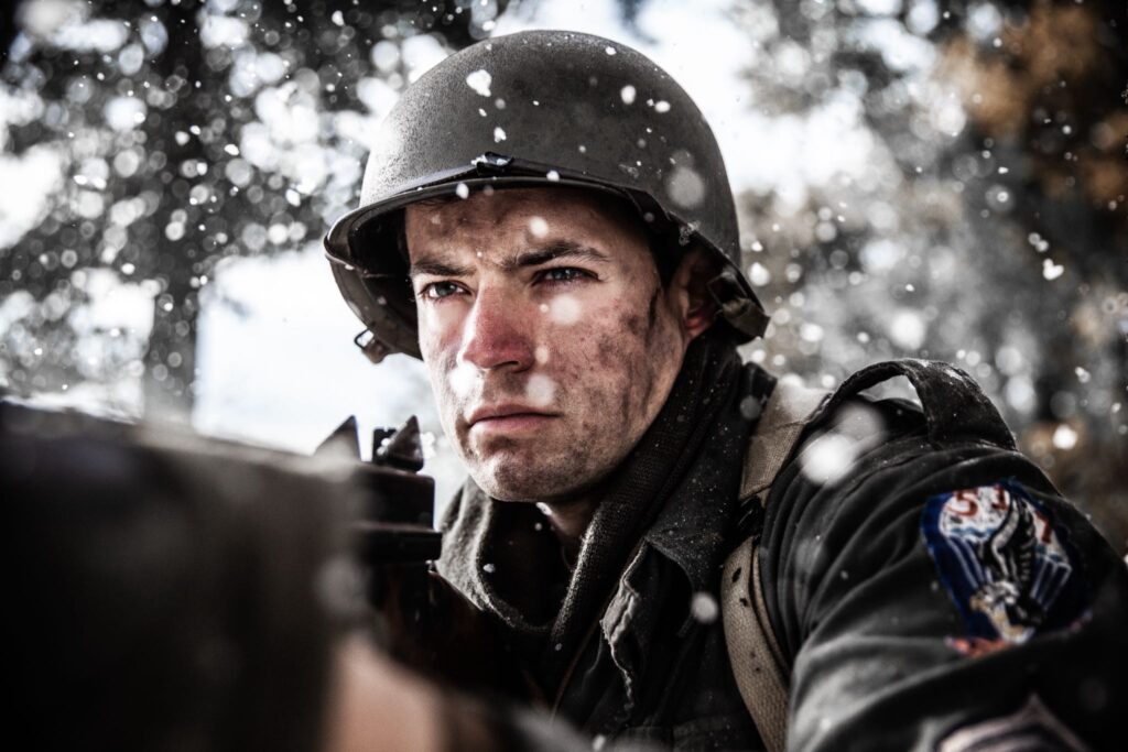 An American Sergeant advances with with his Thompson machine gun through the forest near Hotton, Belgium. (Dramatic Recreation) Joey Mckerricher.