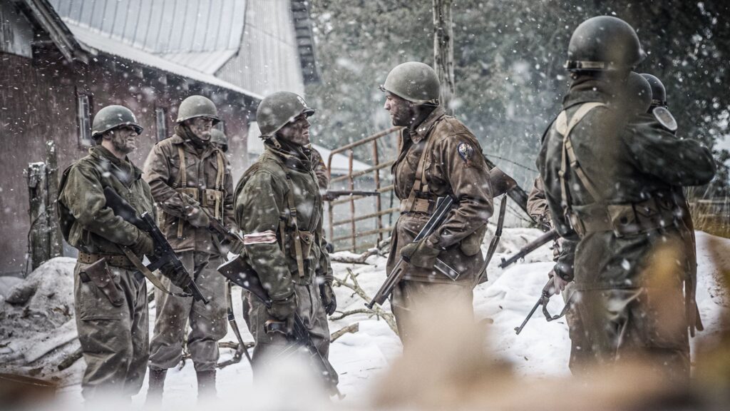 Members of Third Armored Division and 517th Parachute Infantry Regiment link up in Hotton, Belgium. (Dramatic Recreation). (From left to right) Kristian Barret, Joey Mckerricher, William Grossman, and Gavin Marck.