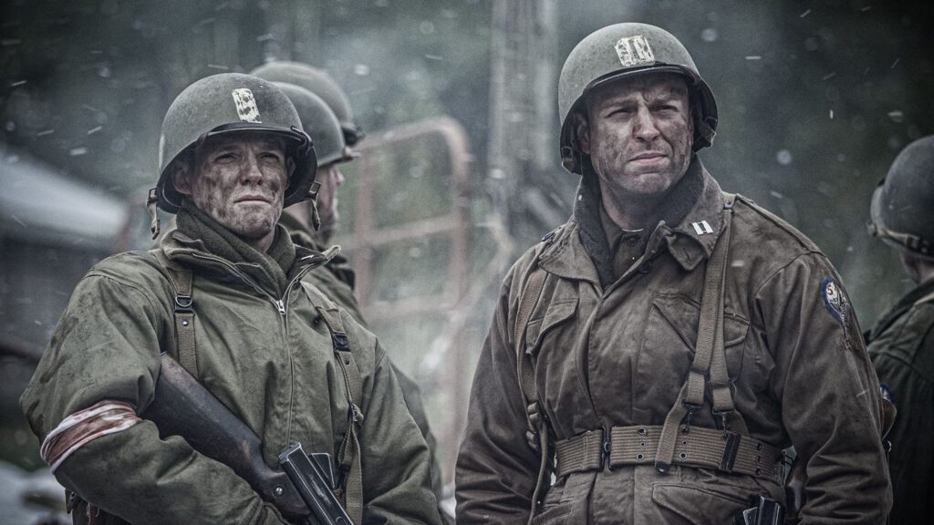 Members of Third Armored Division and 517th Parachute Infantry Regiment link up in Hotton, Belgium. (Dramatic Recreation). (From left to right) William Grossman, and Gavin Marck.