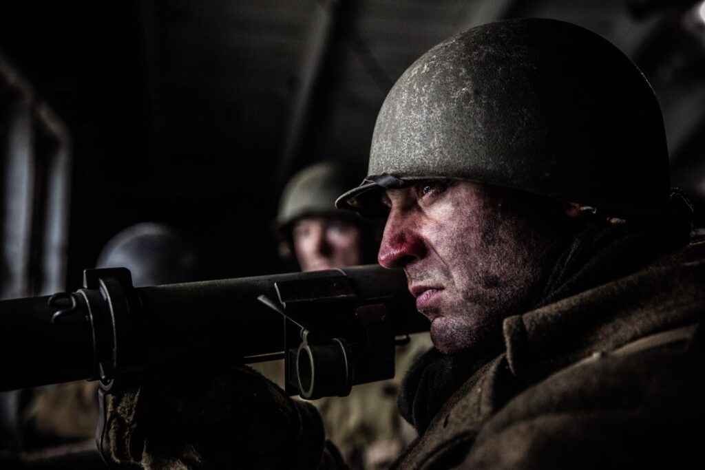 A 242nd Infantry Regiment Soldier aims his Bazooka at a German tank from the church steeple in Hatten, France. (Dramatic Recreation). Joey Mckerricher.