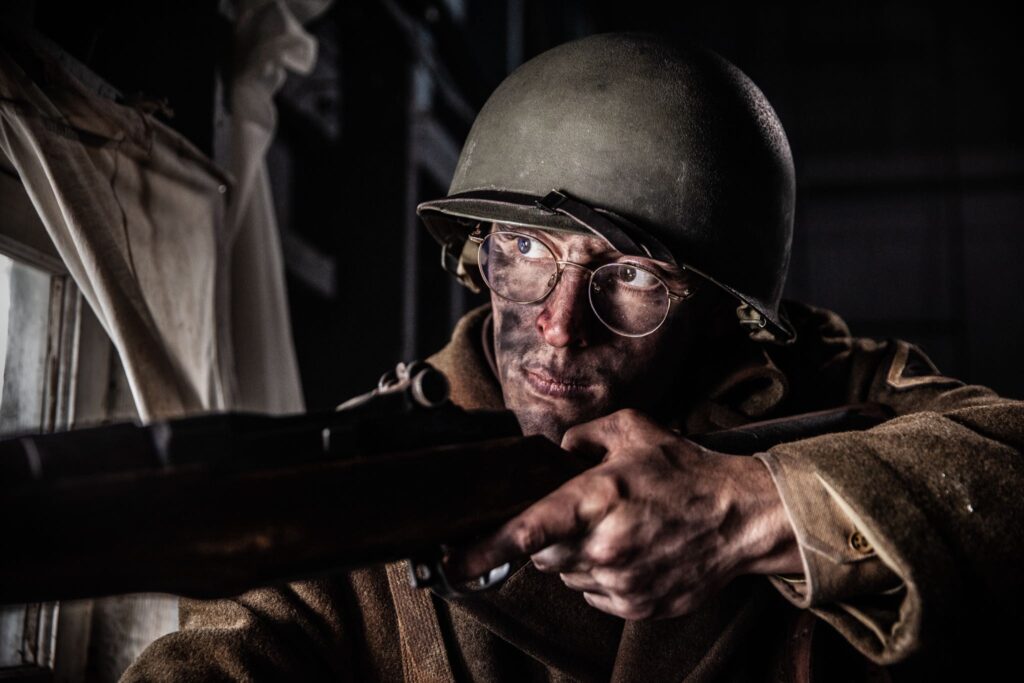 Private First Class Vito Bertoldo takes aim at a German Tank Commander in Hatten, France. (Dramatic Recreation). Boris Bilic.