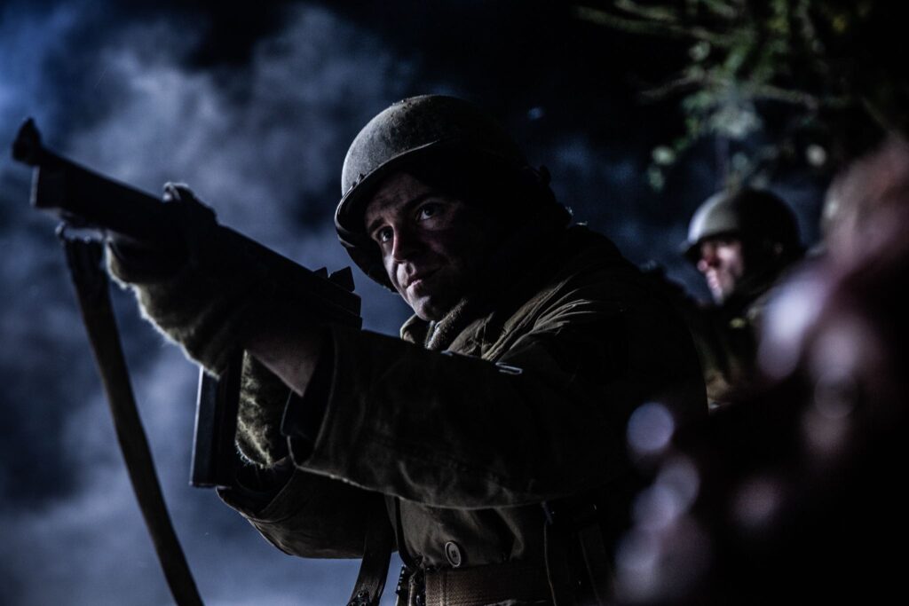 Third Platoon Sergeant, Al Cahoon confronts attacking German forces outside of his Pillbox in the Maginot Line near Hatten, France. (Dramatic Recreation). Pete MacLeod