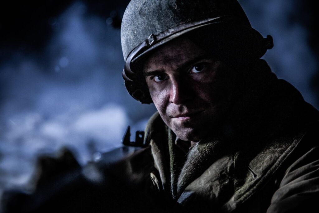 Third Platoon Sergeant, Al Cahoon confronts attacking German forces outside of his Pillbox in the Maginot Line near Hatten, France. (Dramatic Recreation). Pete MacLeod