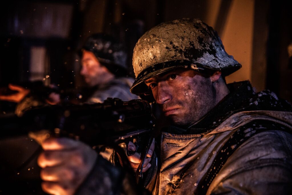 A 35th Panzergrenadier Regiment Soldier aims his machine gun during the attack of Hatten, France. (Dramatic Recreation). David Bell.