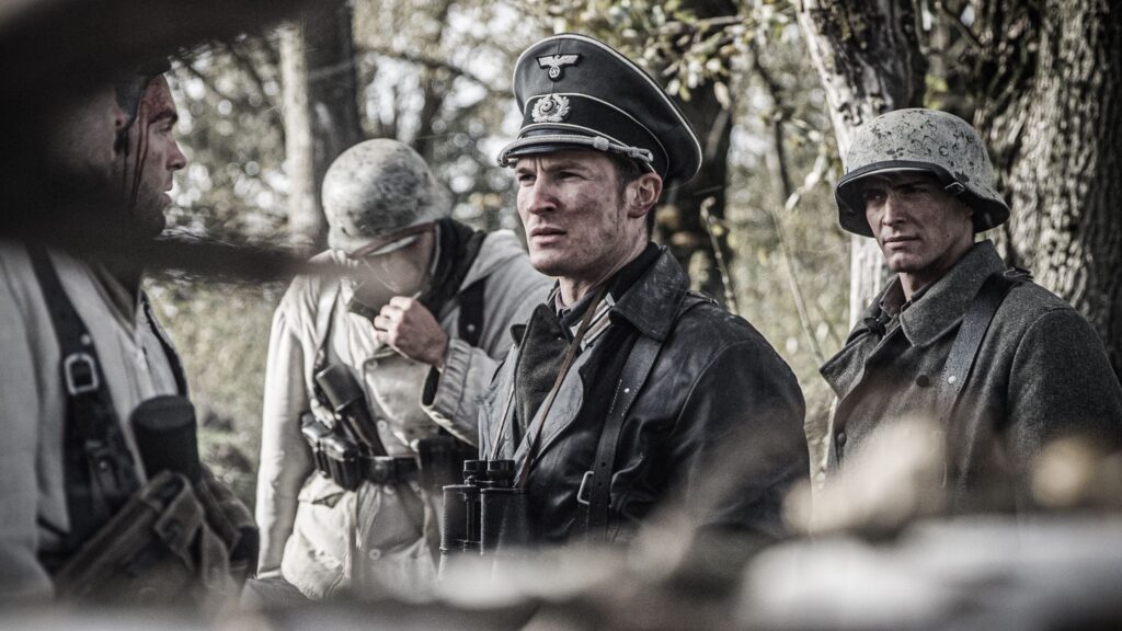 Lieutenant Colonel Karl Proll prepares soldiers of the 35th Panzergrenadier Regiment for their attack on the Maginot Line. (Dramatic Recreation). (Left to Right) Etienne Cote, Mark Masterton,and Kaden Connors.