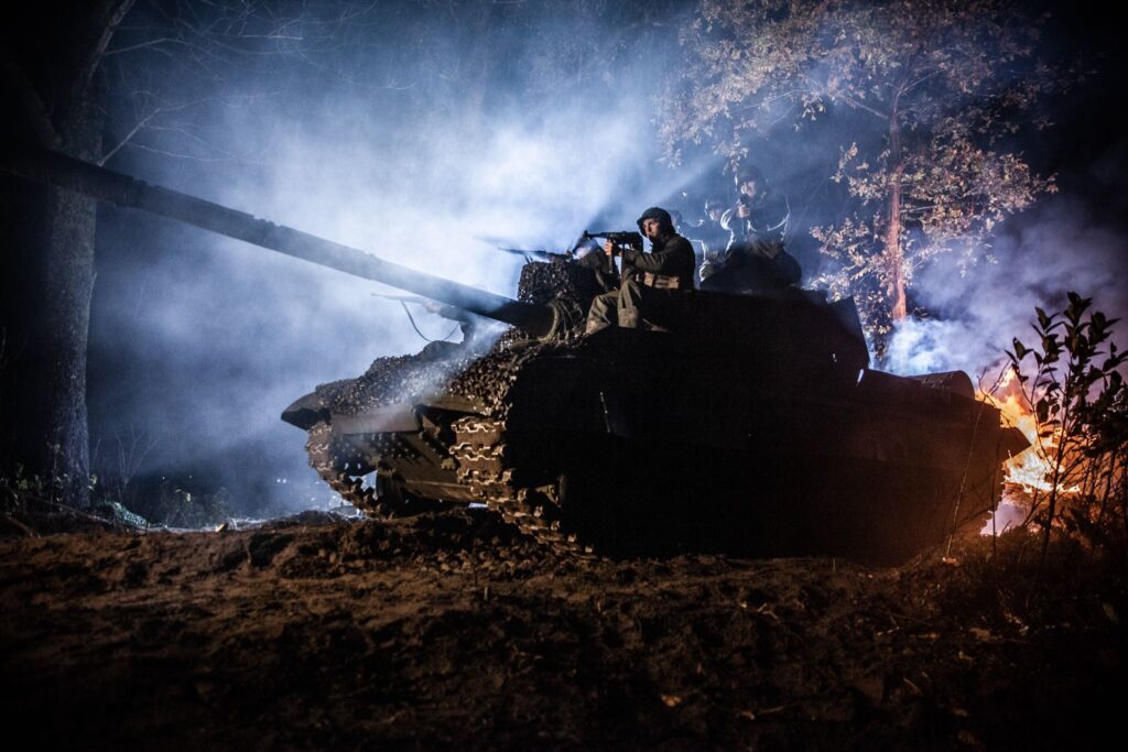 Soldiers of the 9th Panzer Grenadier Regiment advance on a German tank in Northern Italy. (Dramatic Recreation) (Left to Right) Alessandro Pekin, Mark Masterton, & Etienne Cote.