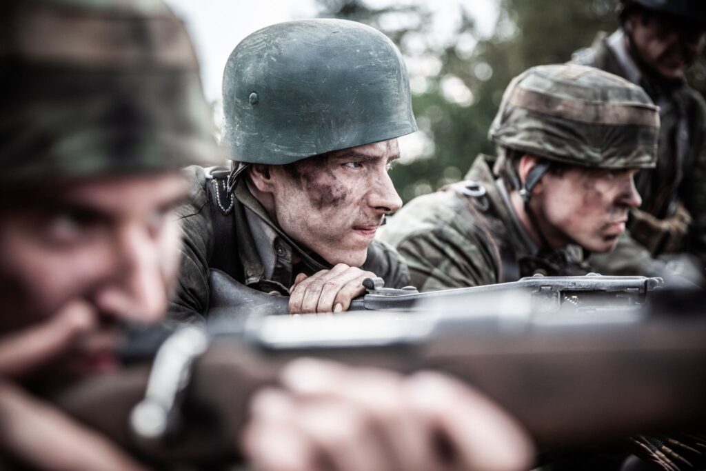 German machine gunner fires during an attack against French partisans on the Vercors Plateau. (Dramatic Recreation) (Chase Hansen, Liam Rusel)