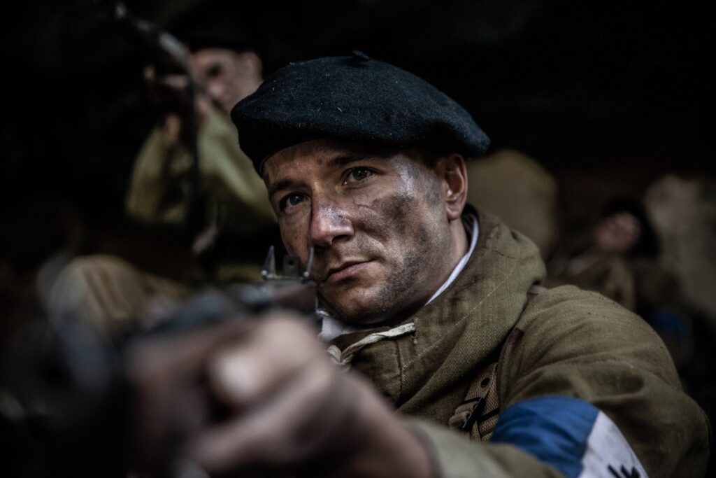 French Lieutenant Paul Blanc prepares to defend a cave above the Pas de l'Aiguille as German soldiers swarm below. (Dramatic Recreation) (Christopher Formica)