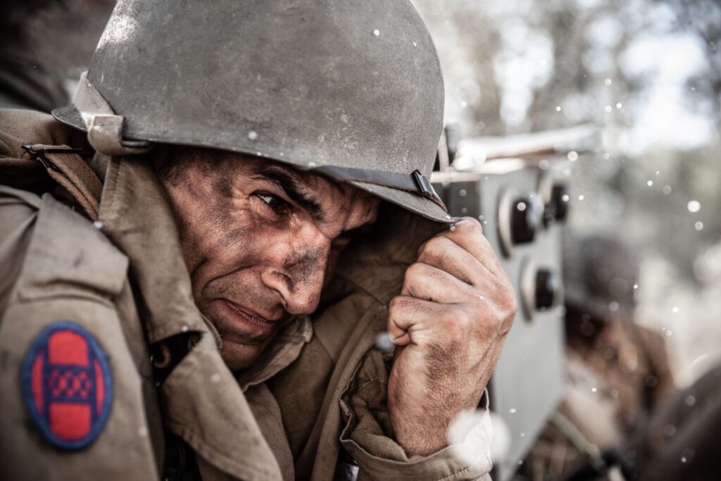 U.S. Sergeant Ammon Sasser takes cover after a German shell scatters white phosphorus. (Dramatic Recreation) (Kevin Trumble)