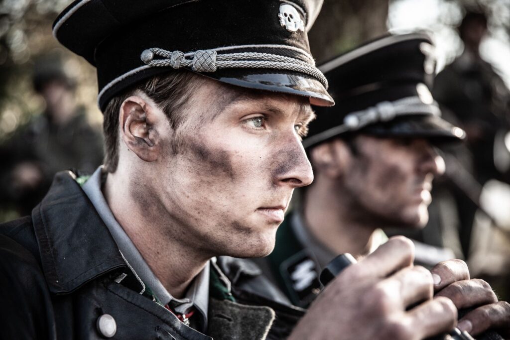 Obersturmbannfuhrer Jakob Fick and Untersturmführer Ortwin Kuske coordinate an attack on Hill 314. (Dramatic Recreation) (L-R: Jarret Aikman, Amir Zeino)