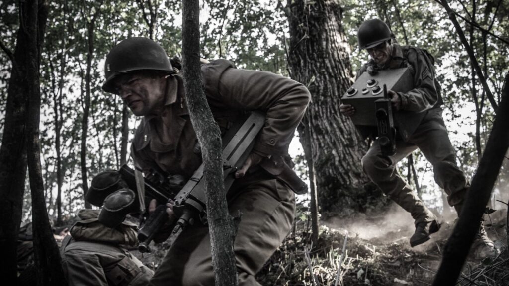 Lietenant Robert Weiss and Sgt Ammon Sasser rush to join the front line with radio equipment in hand. (Dramatic Recreation) (L-R: Nathan Plumite, Kevin Trumble)