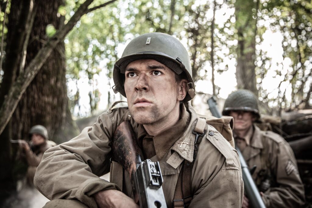 Lieutenant Harris Neil monitors the attack against a German bunker. (Dramatic Recreation) (L-R: Jonathan Woodhall, Kaden Connors)