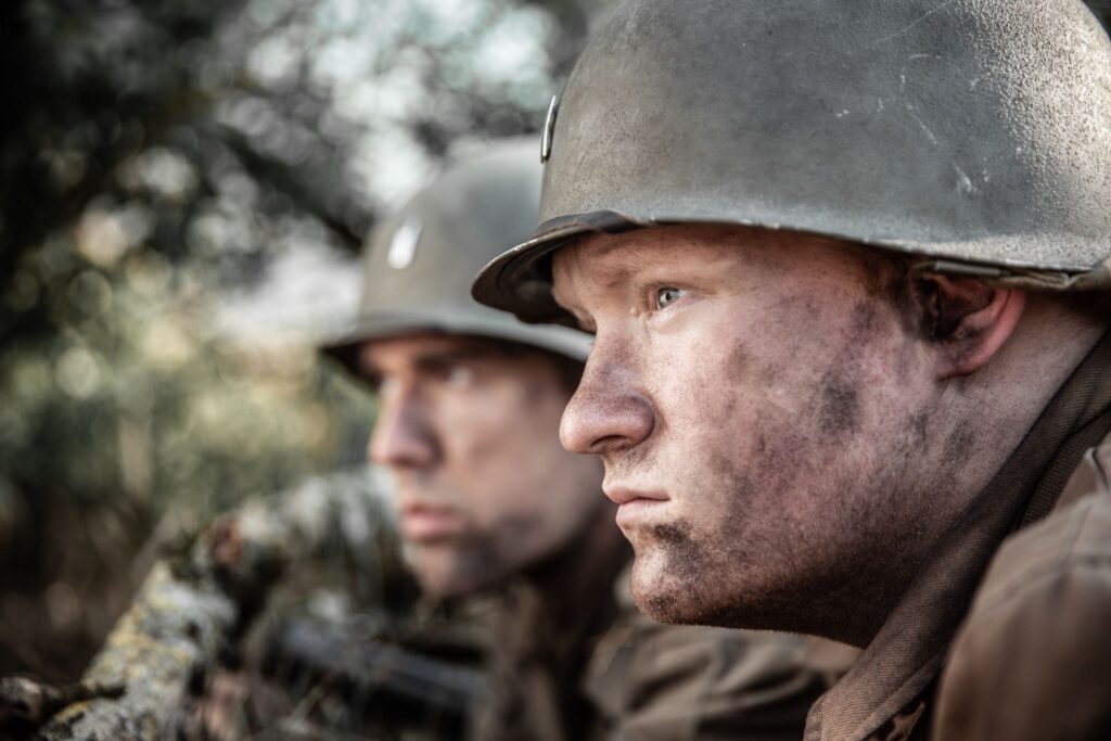 Lieutenants Harris Neil and Rex Ross crawl amidst enemy artillery fire to the next enemy bunker. (Dramatic Recreation) (L-R: Jonathan Woodhall, Kyler Fagan)