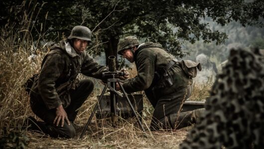 German soldiers set up and load the mortar. (Dramatic Recreation) (L-R: Jarret Aikman, Jonathan Woodhall)