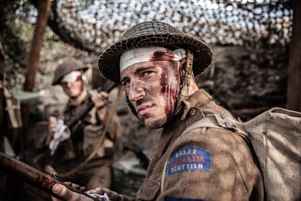 Wounded Canadian soldiers clean weapons and load magazines to help those still able to fight. (Dramatic Recreation) (Zak Parlette)