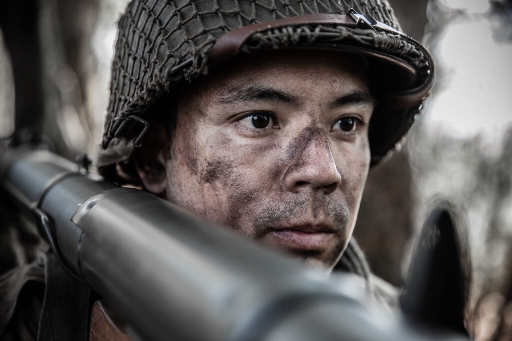 Private First Class Francisco Delgado fires a bazooka at a German machine gun nest in the Hurtgen Forest. (Dramatic Recreation) (Harry Tamacas Perla)