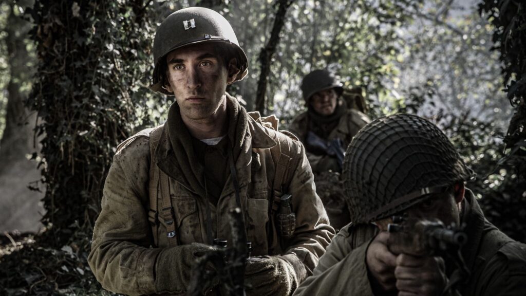 American Captain Robert Moore prepares an attack in the Hurtgen Forest. (Dramatic Recreation) (L-R: Dylan Araki, William Grossman & Kayler Fagan)