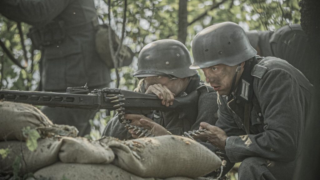 A German machine gun nest targets soldiers of the U.S. 8th Infantry Regiment in the Hurtgen Forest. (Dramatic Recreation) (L-R: Amir Zeino & Marcel Heim)