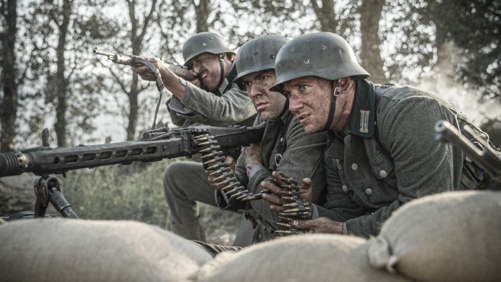 A German machine gun nest readies to attack soldiers of the U.S. 8th Infantry Regiment in the Hurtgen Forest. (Dramatic Recreation) (L-R: Petar Gatsby, Jonathan Woodhall, Christopher Formica)