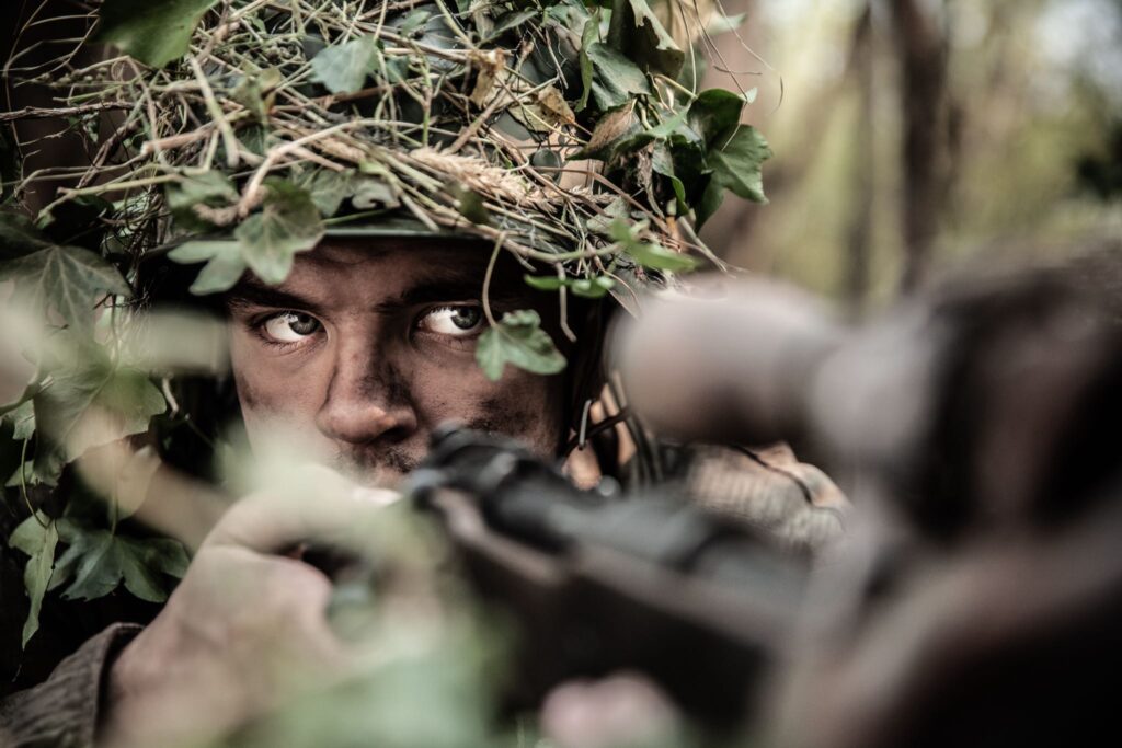 A German sniper blends into the woods. (Dramatic Recreation (Lincoln Tisdale)