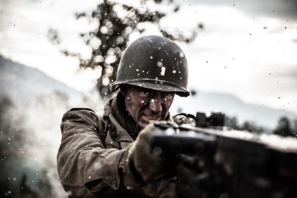 2nd Lieutenant Audie Murphy swings the 50-caliber gun into position to fire on the attacking German infantry. (Dramatic Recreation) (William Redfern)